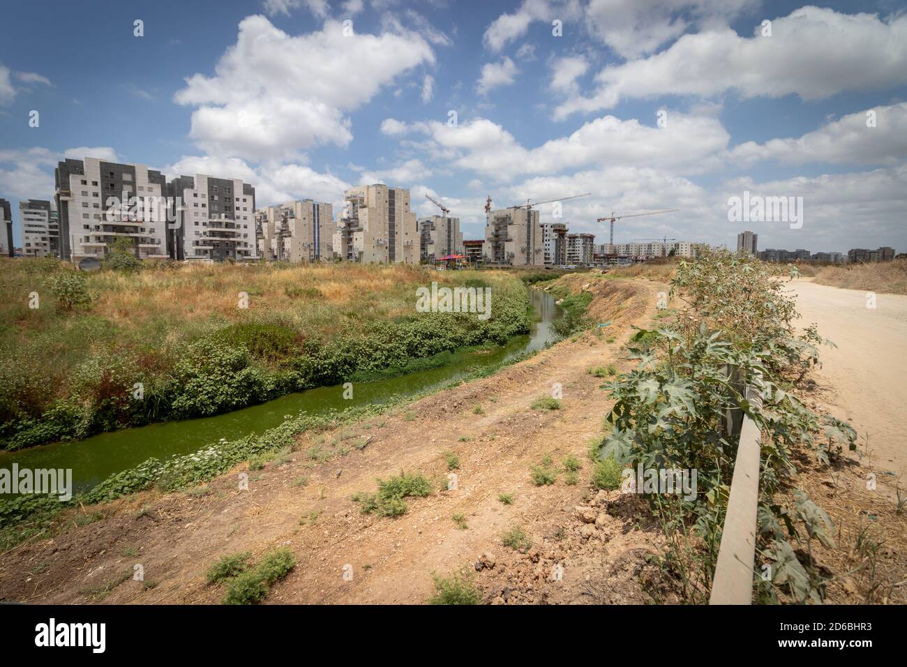 Ganei Ayalon neighborhood at the entrance to Moshav Ahisamakh and a55 stream that flows near the neighborhood, new buildings against a background of c Stock Photo