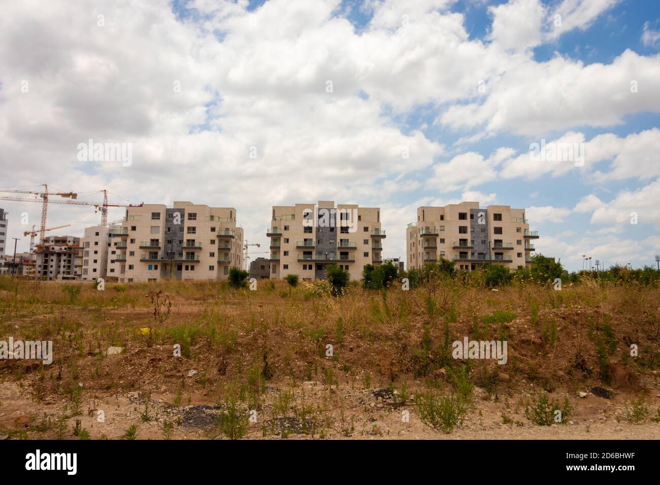 Ganei Ayalon neighborhood at the entrance to Moshav Ahisamakh, new buildings against a background of cloudy skies Stock Photo
