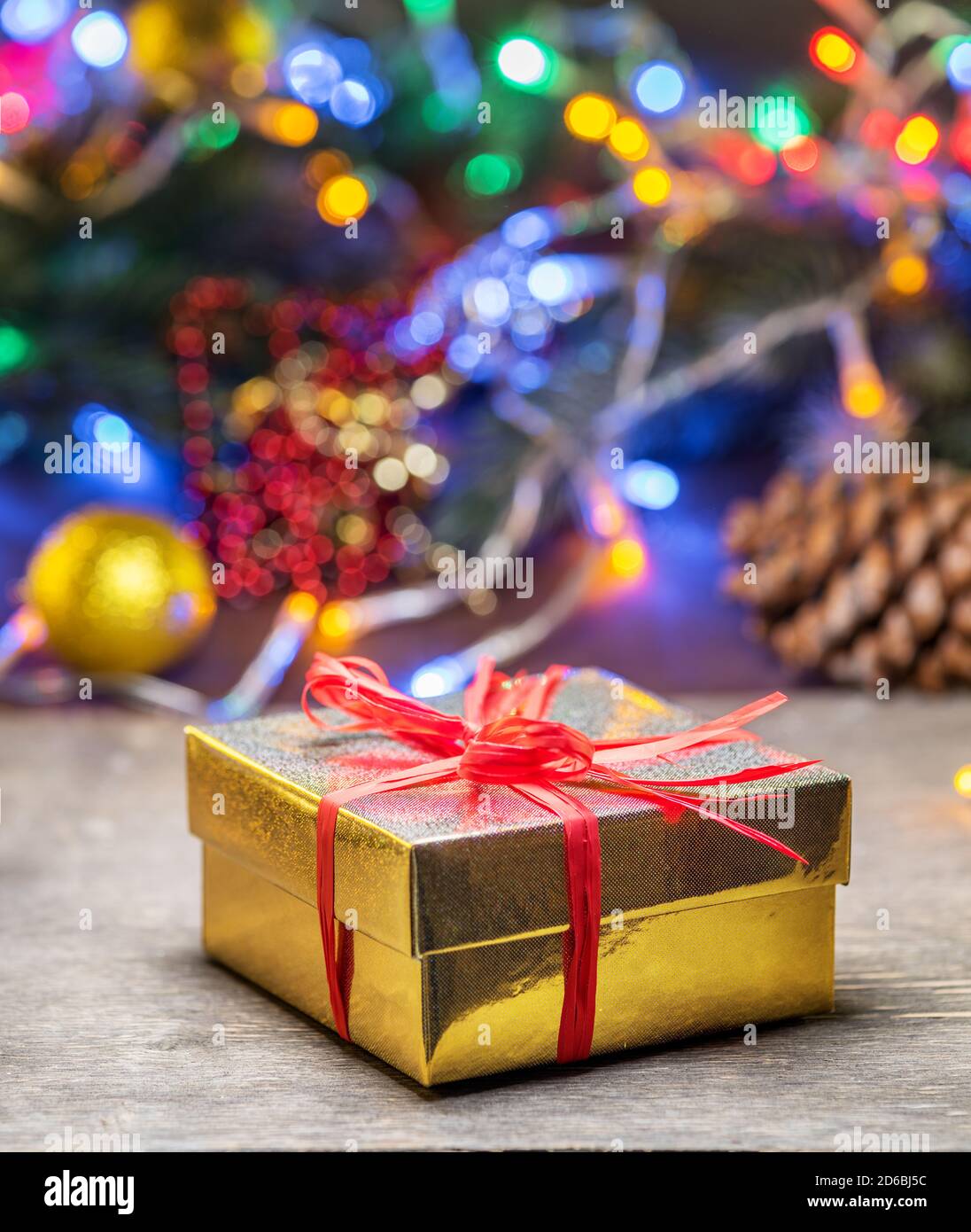Beautiful Christmas gifts in decorated boxes near a Christmas tree in the home. Stock Photo