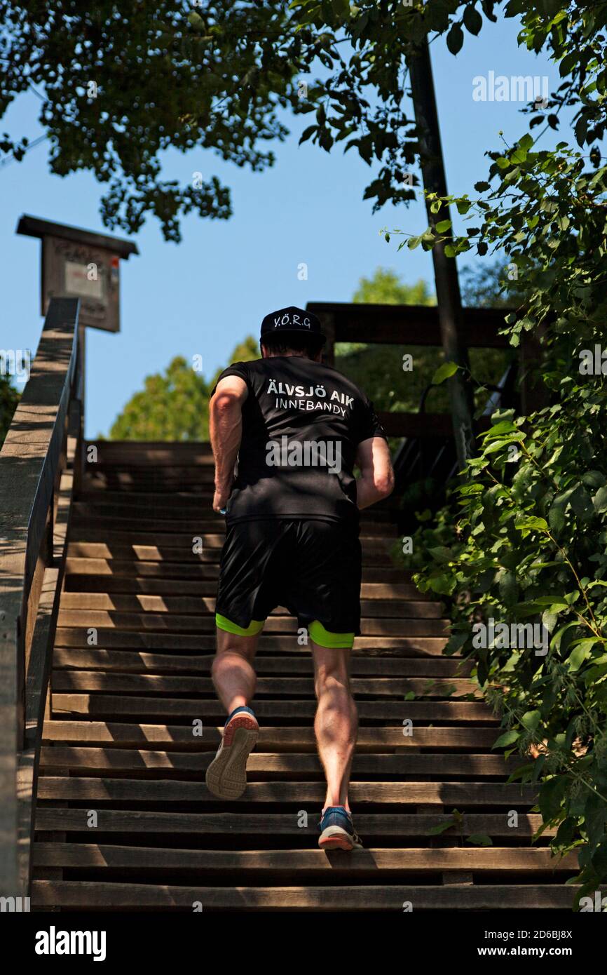Umea, Norrland Sweden - June 20, 2020: the back of a young man running up  the stairs Stock Photo - Alamy