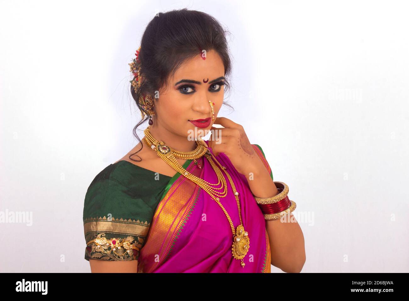 Indian model dressed in Maharashtrian bridal wear with purple Sari ...