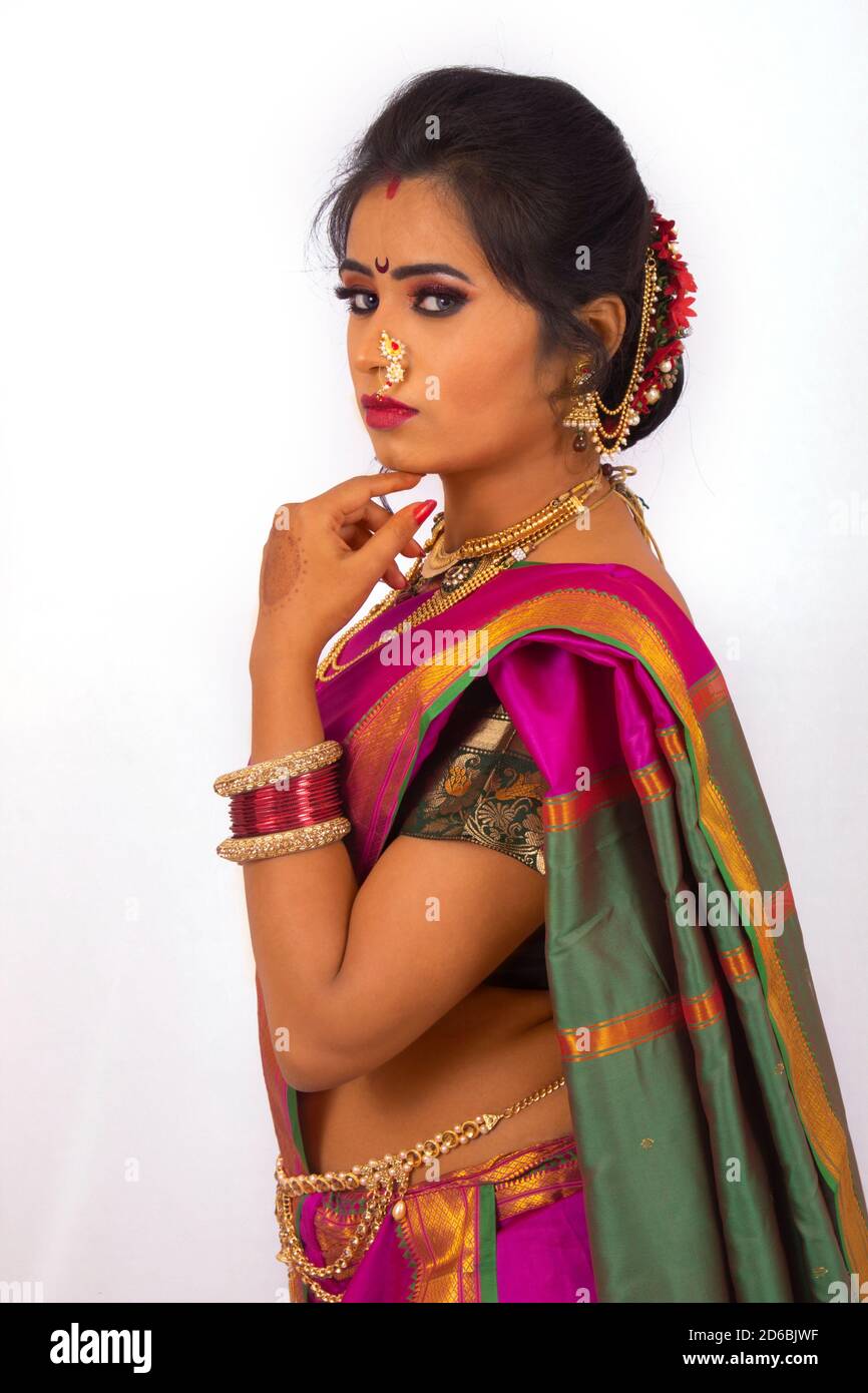 Indian model dressed in Maharashtrian bridal wear with purple Sari. Side profile. Stock Photo