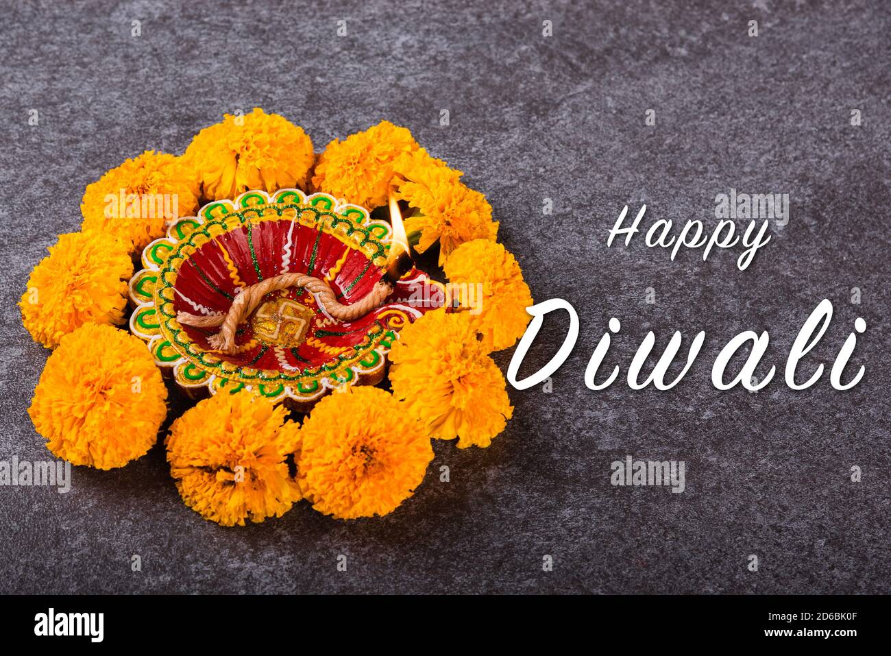 Top view overhead clay lit Diya or oil lamp and yellow flower, studio shot  on concrete background, Decoration of Hinduism rangoli, Happy Deepavali or  Stock Photo - Alamy