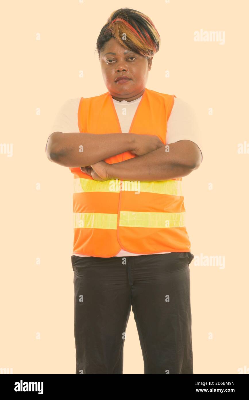 Studio shot of fat black African woman construction worker standing ...