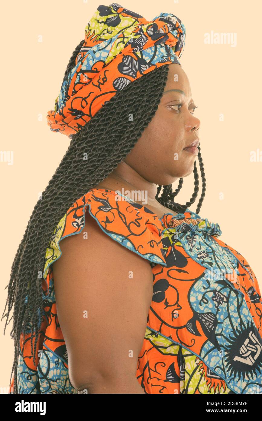 Profile view of fat black African woman wearing traditional clothes Stock Photo