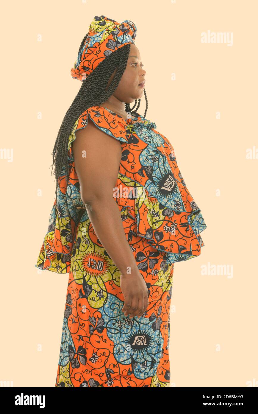 Profile view of fat black African woman standing while wearing traditional clothes Stock Photo