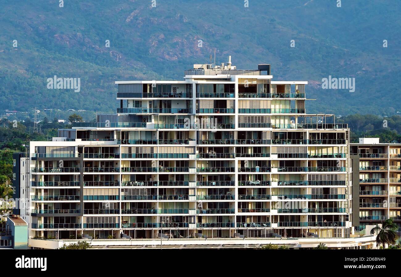 Townsville, Queensland, Australia - June 2020: A high rise residential building with many floors against a mountain backdrop Stock Photo