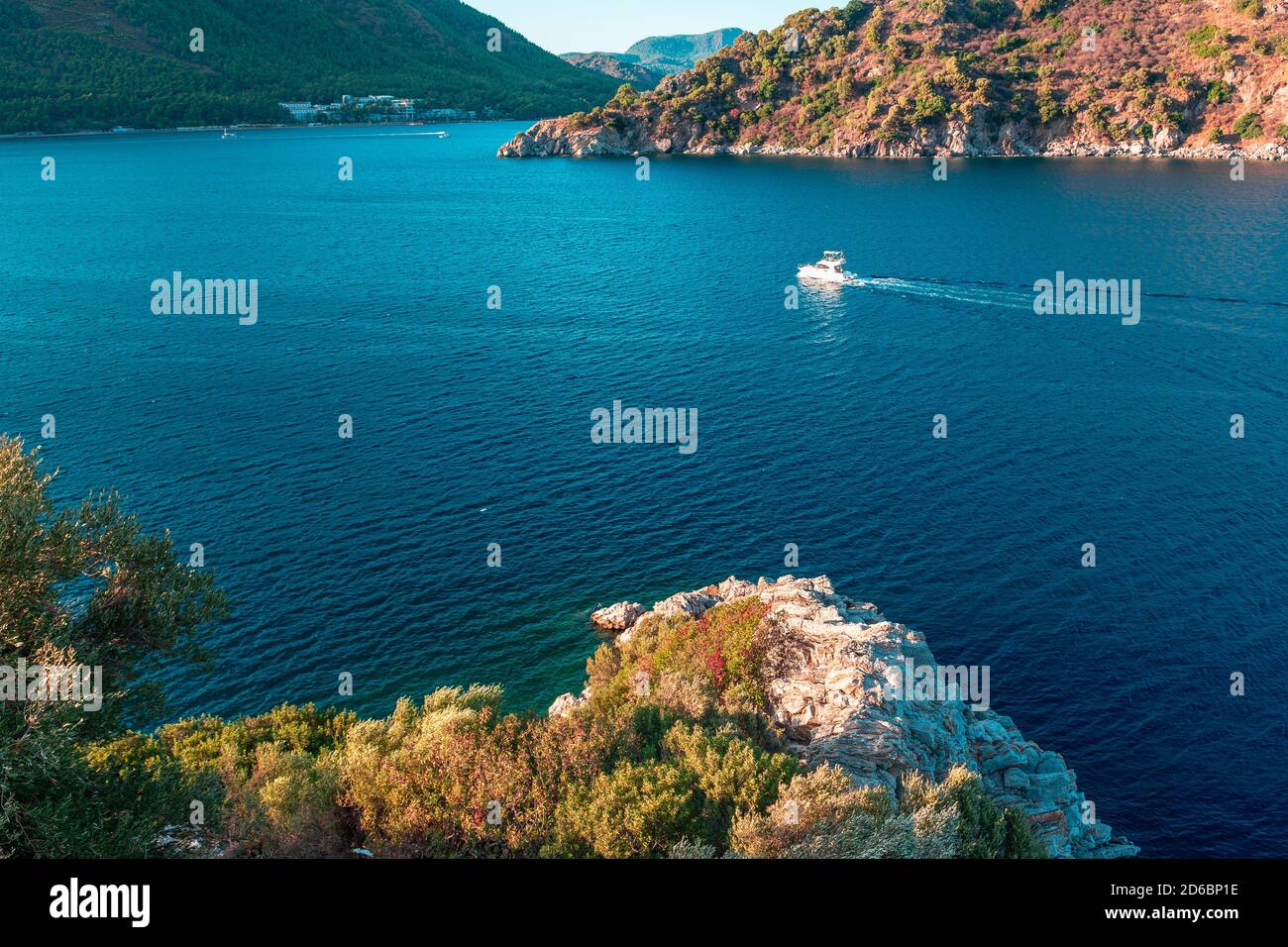 Aerial view rocks, waves and small boat. Summer landscape with sea and mountain range. Sea aerial view. Landscapes of Turkey city of Marmaris. Aerial Stock Photo
