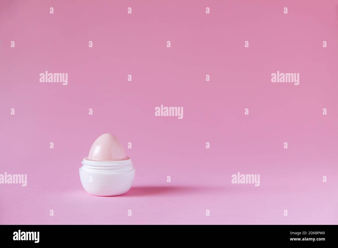 Lip balm for dry lips in small white plastic container on soft pink background Stock Photo Alamy