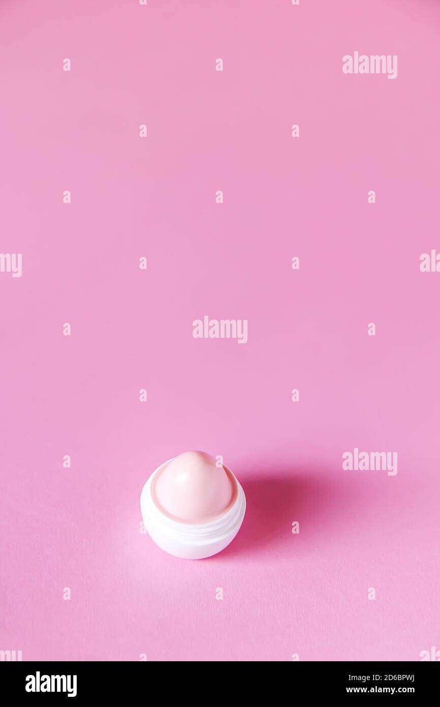 Lip balm for dry lips in small white plastic container on soft pink background Stock Photo Alamy