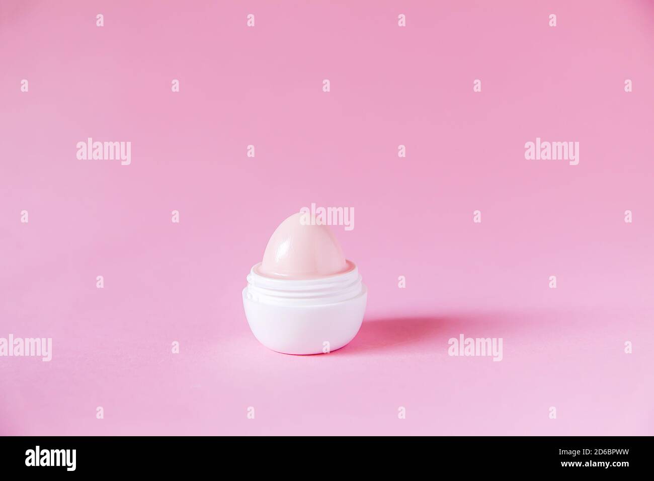 Lip balm for dry lips in small white plastic container on soft pink background Stock Photo Alamy