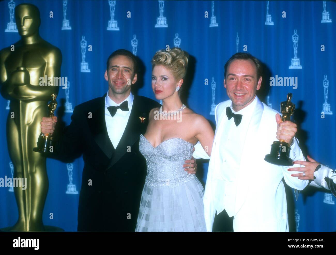 Los Angeles, California, USA 25th March 1996 (L-R) Best Actor Winner Nicolas Cage ('Leaving Las Vegas'), Best Supporting Actress Winner Mira Sorvino ('Mighty Aphrodite'), Best Supporting Actor Winner Kevin Spacey ('The Usual Suspects') pose with their Oscars in press room at the 68th Annual Academy Awards at Dorothy Chandler Pavilioin on March 25, 1996 in Los Angeles, California, USA. Photo by Barry King/Alamy Stock Photo Stock Photo