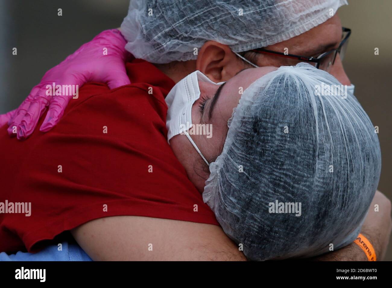 Brasilia, Brazil. 15th Oct, 2020. Health workers hug each other to celebrate the closure of a temporary hospital at the National Stadium in Brasilia, Brazil, Oct. 15, 2020. The temporary hospital is closed on Thursday. Since its establishment on May. 22, the hospital has received more than 1,800 COVID-19 patients. Credit: Lucio Tavora/Xinhua/Alamy Live News Stock Photo