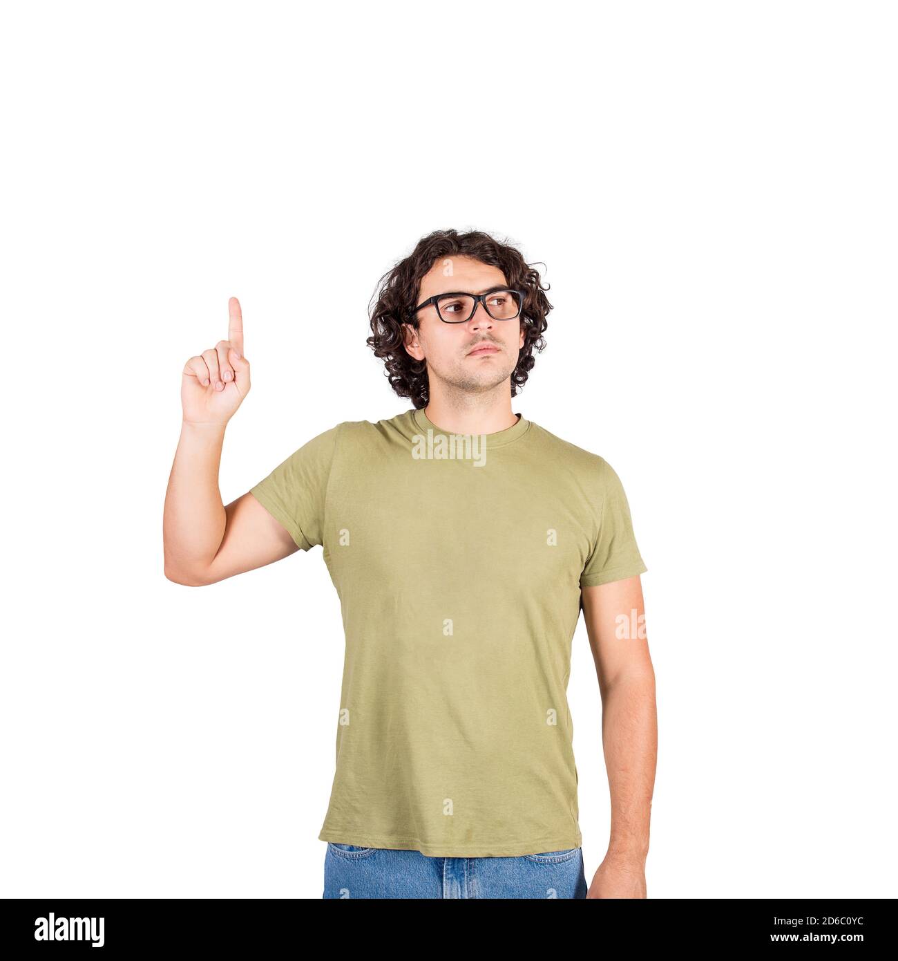 Serious casual man pointing up index finger while looking aside, isolated on white background with copy space. Calm person, wearing eyeglasses, shows Stock Photo