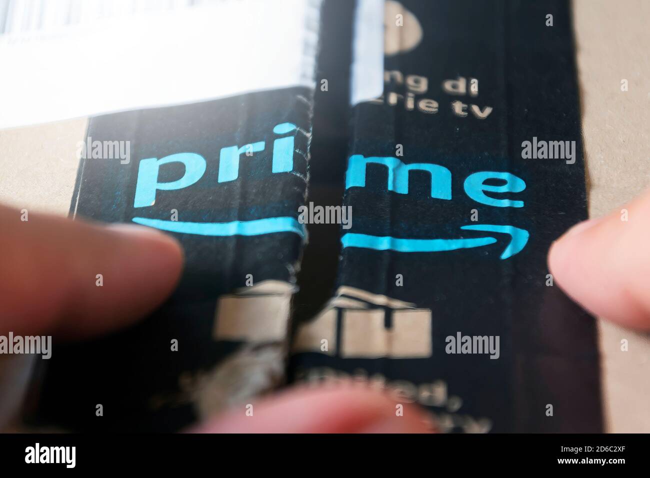 Rome, Italy, august 2020: opening a box shipped by Amazon Prime. Business and online shopping. International shipments. Cardboard packaging Stock Photo