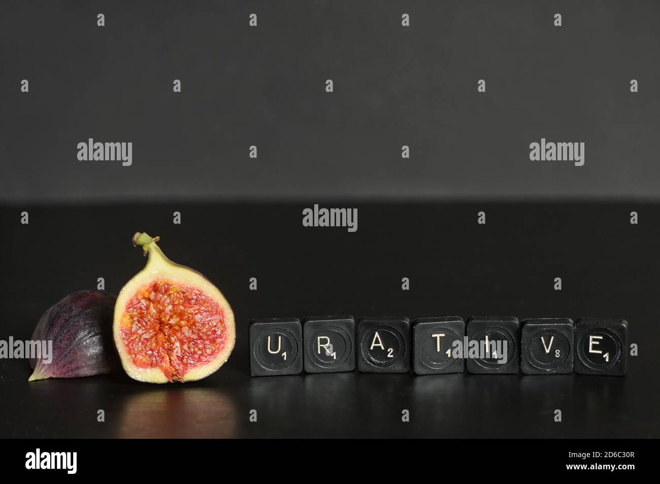 Idea Figurative made from Figs and Scrabble Tile Word on black table