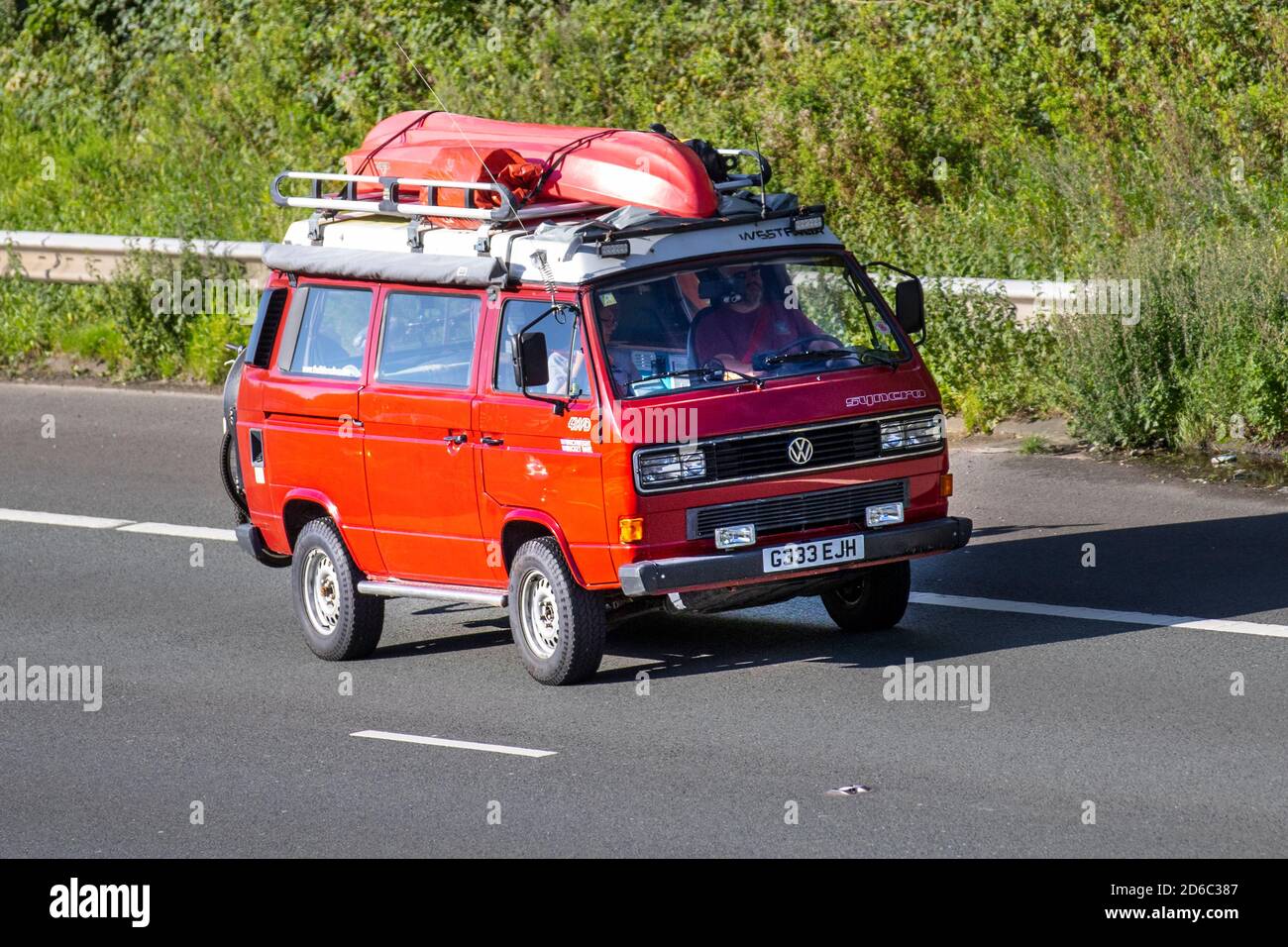 1989 80s Red VW volkswagen Vanagon Westfalia Syncro Caravans and Motorhomes, campervans on Britain's roads, RV leisure vehicle, family holidays, caravanette vacations, Touring caravan holiday, van conversions, Vanagon autohome, life on the road, Stock Photo