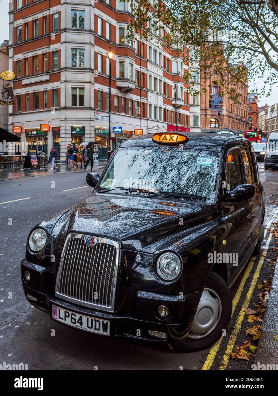 London Taxi waiting for customers, with for hire signs on. London Black Cab waiting for passengers. Stock Photo