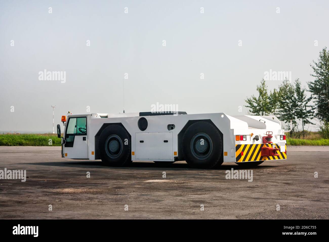 Airplane tow truck at the airport apron Stock Photo - Alamy