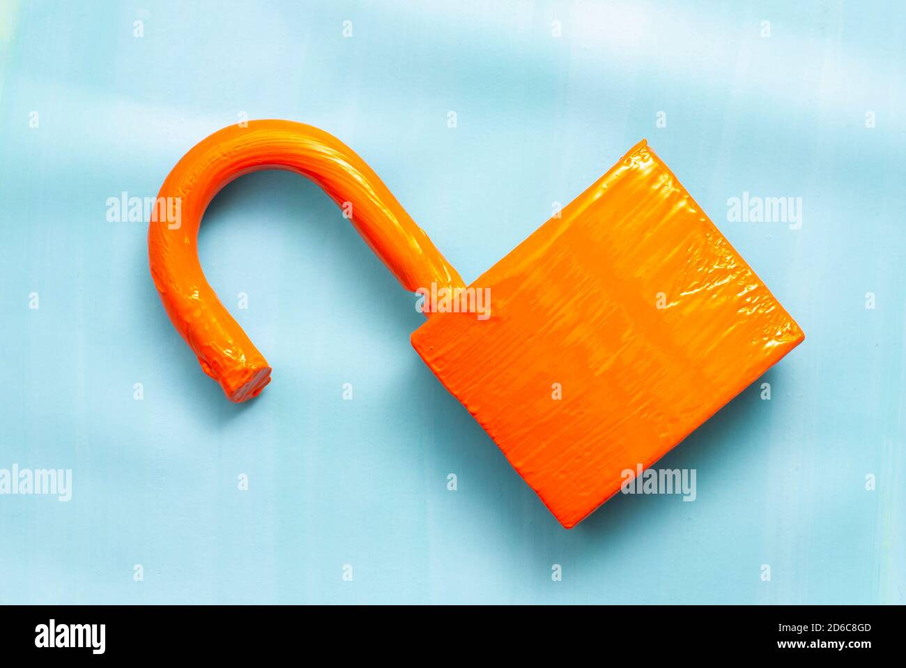 Orange padlock on blue background. Stock Photo