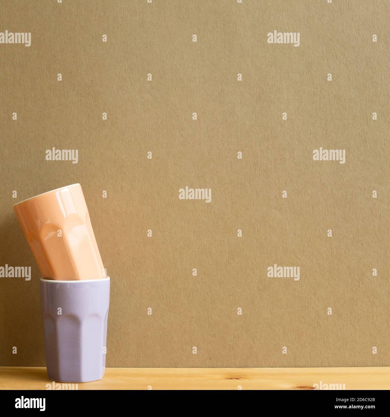 Stack of ceramic cups on wooden table with brown background Stock Photo