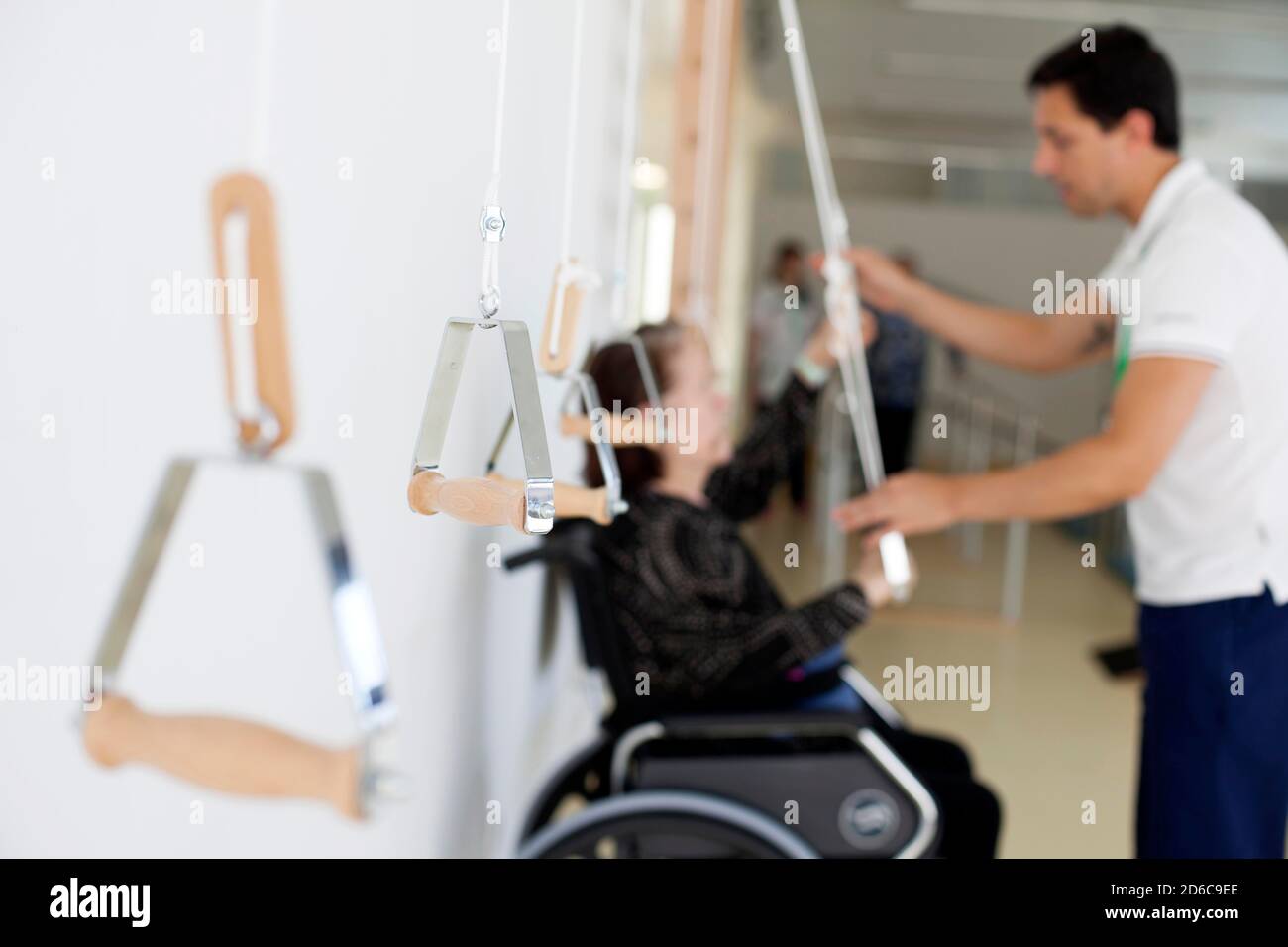 Physical therapist working with patient on upper extremity exercise