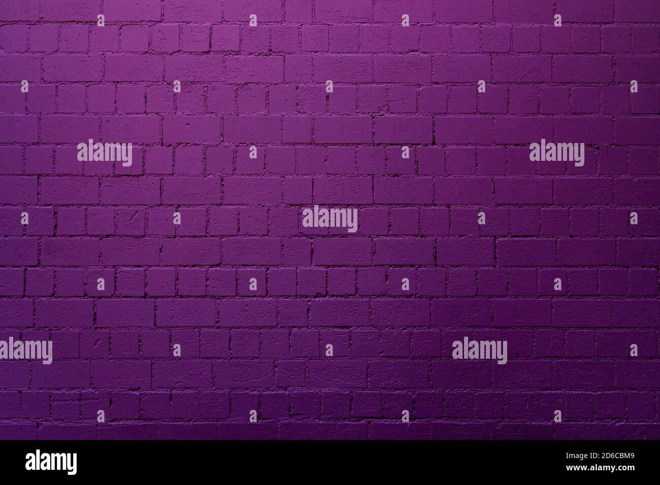 Purple brick wall background with shades of light and dark purple Stock Photo