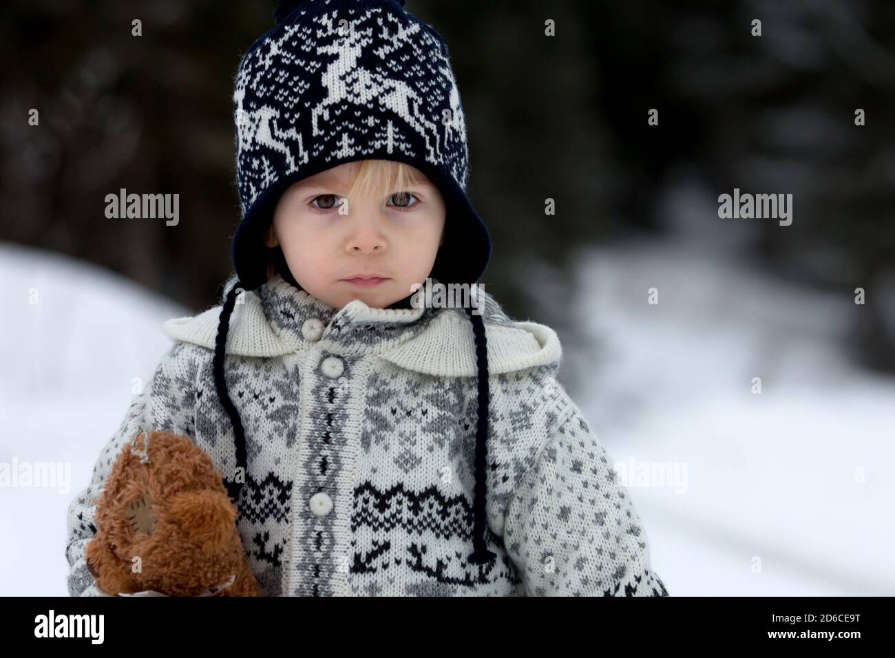 Cute boy playing with teddy bear in the snow, winter time. Little ...