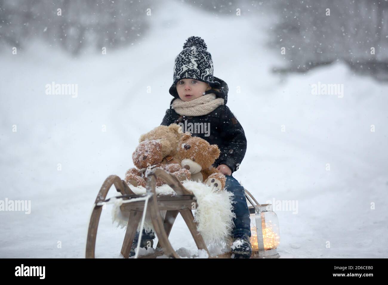 Cute boy playing with teddy bear in the snow, winter time. Little ...