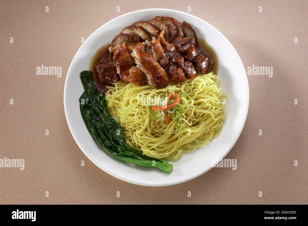 Asian style noodles with roasted duck and sticky pork spare ribs Stock Photo