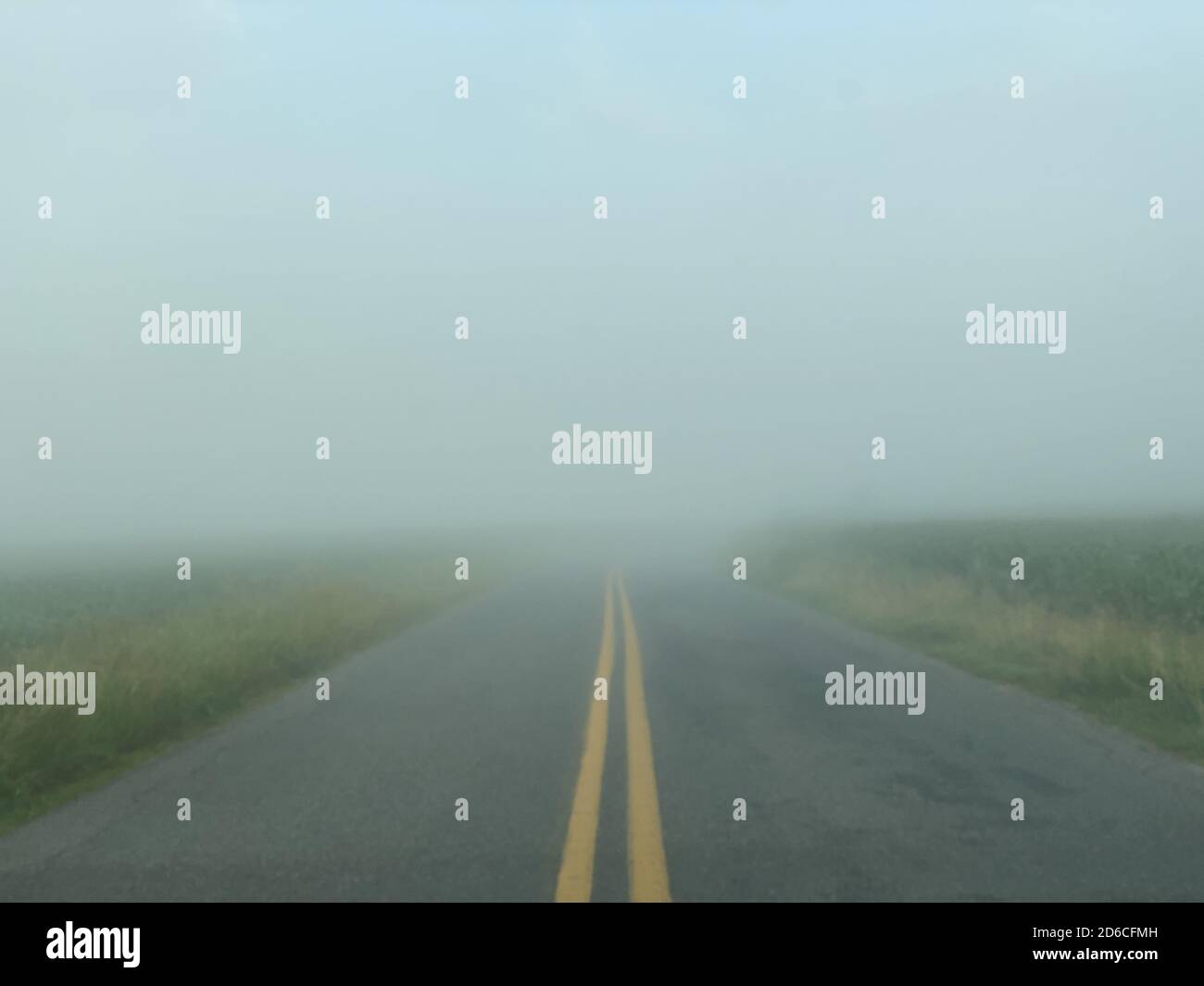 Road through the countryside on a foggy day Stock Photo - Alamy