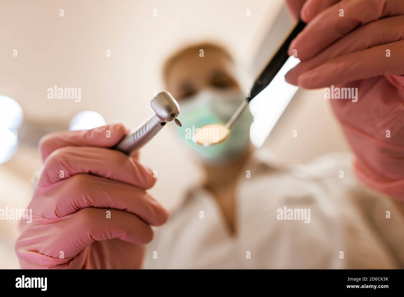 Dentist holding drill and mirror Stock Photo