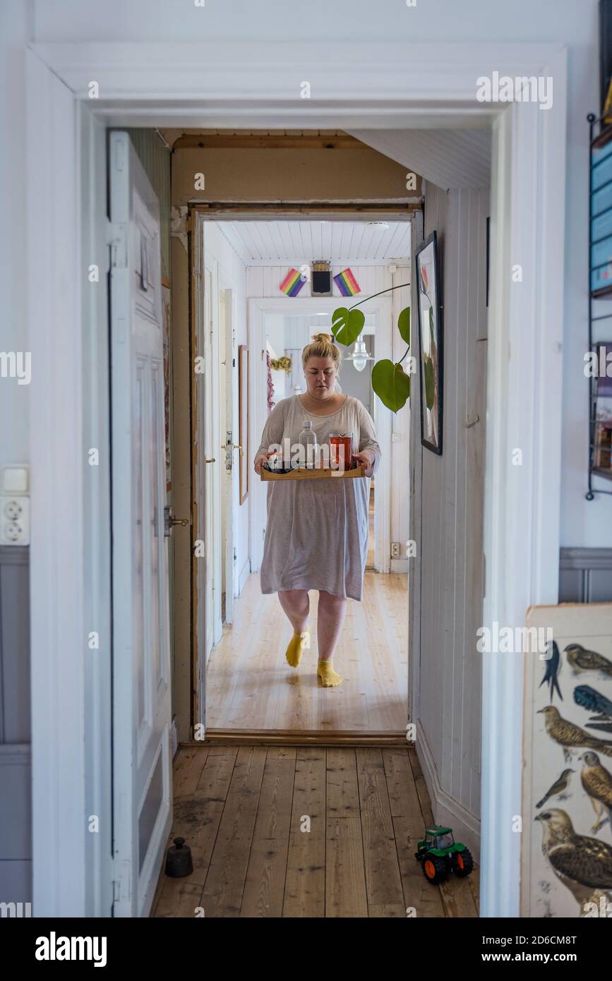 Woman carrying tray Stock Photo Alamy