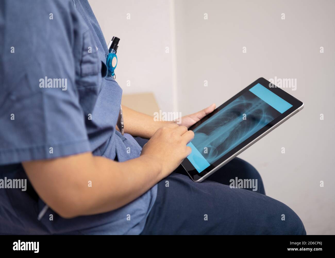 Hands holding digital tablet showing X-ray Stock Photo