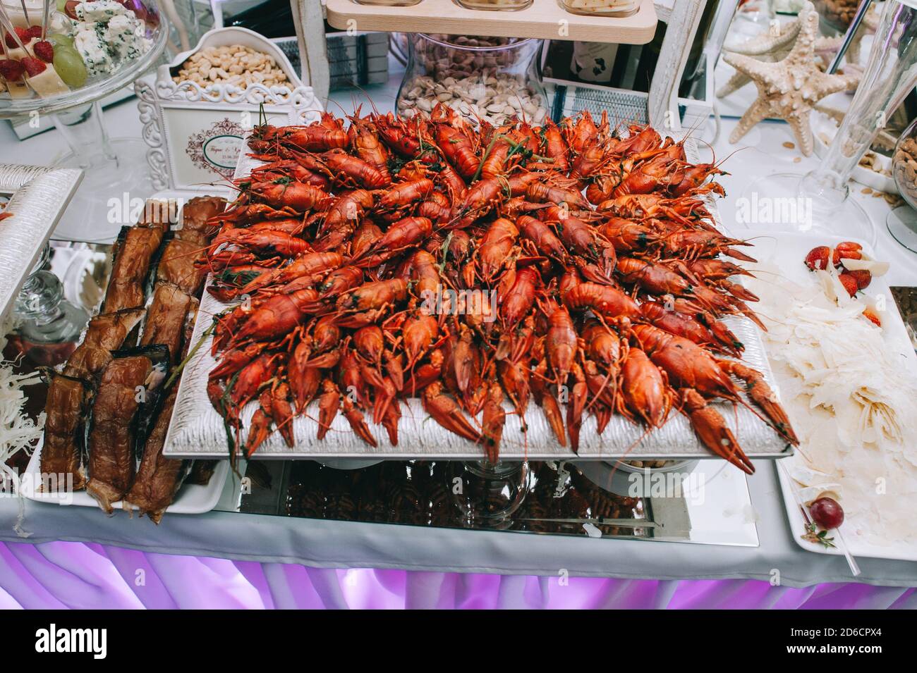 Large square plate of delicious crayfish and lobsters with on the wedding buffet table. Stock Photo