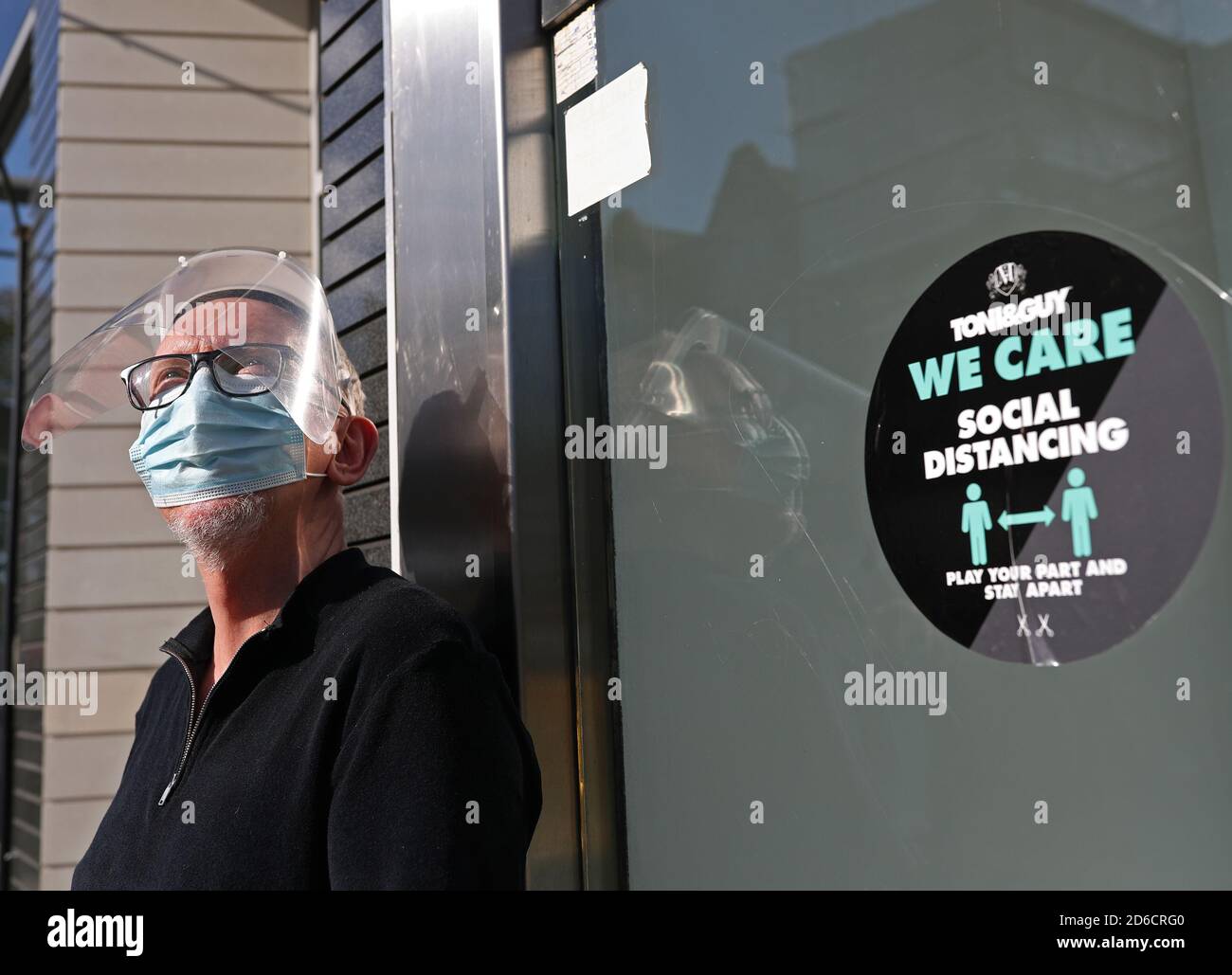 Dennis Mocock, Art Director at Toni & Guy Ealing, London, taking a break outside his salon, after Mayor of London Sadiq Khan has announced that London will be moved to Tier 2 coronavirus restrictions from midnight on Friday. Stock Photo