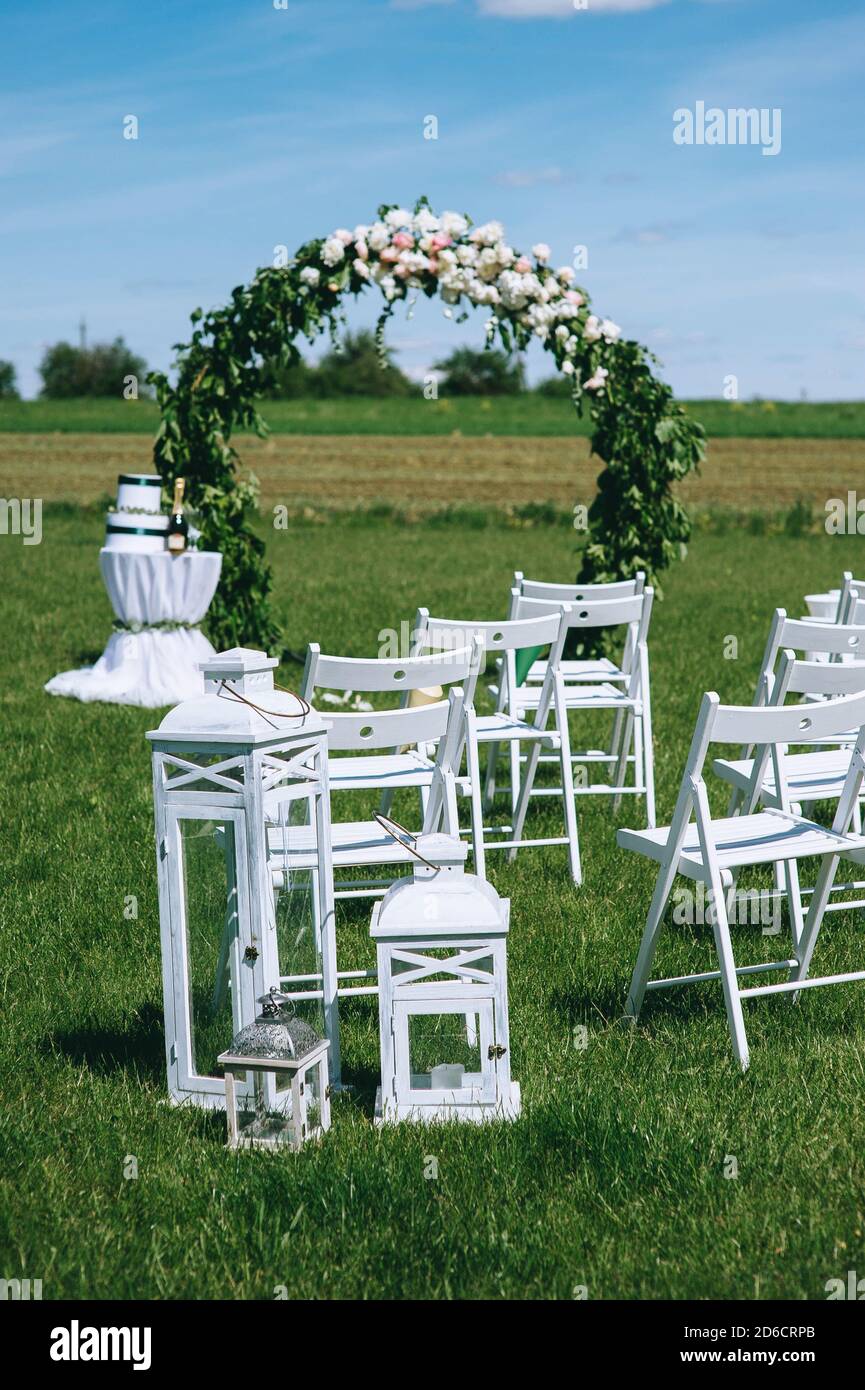 Round wedding arch decorated with peonies and greenery with white