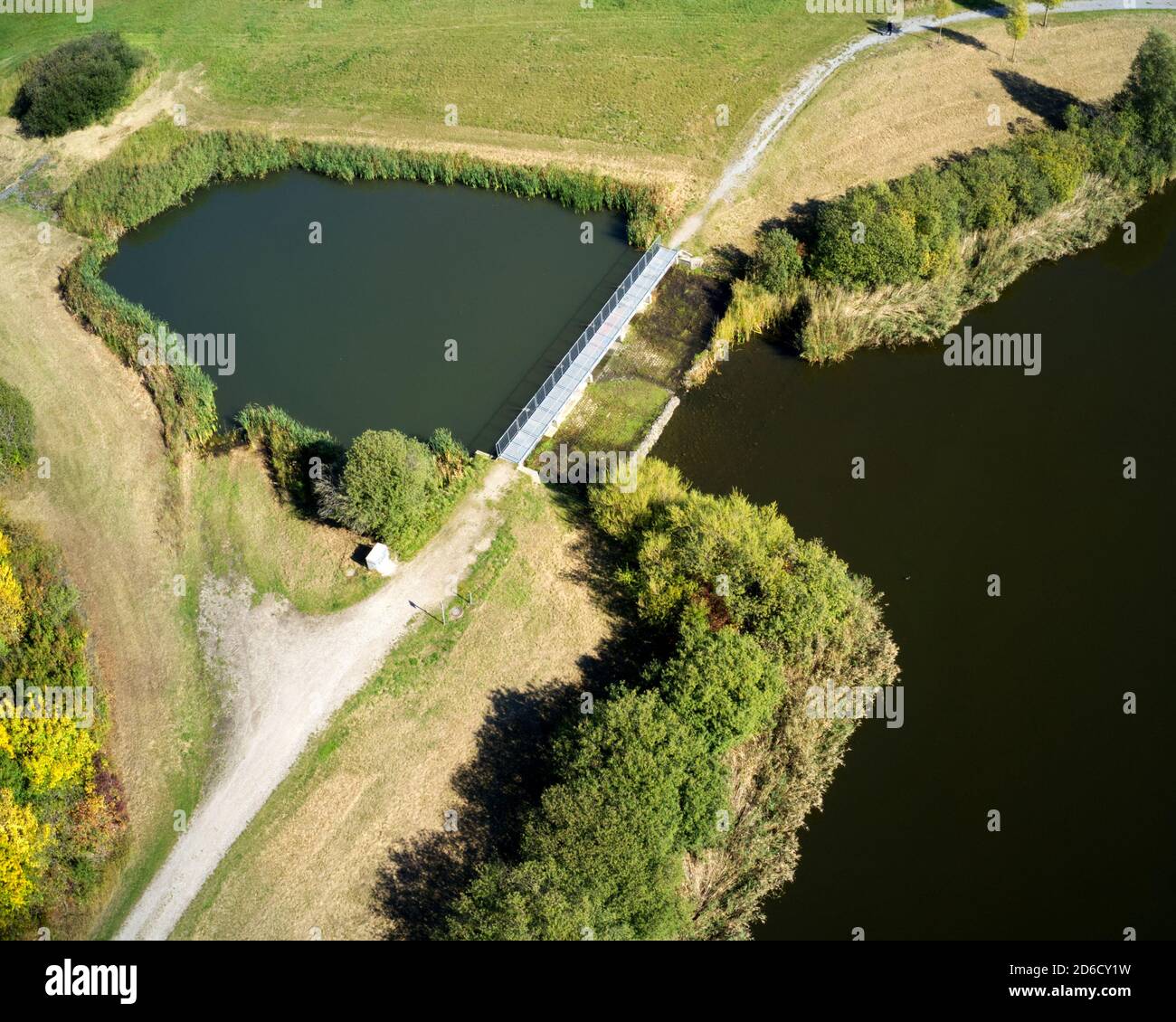 Aerial view of the antechamber of a rainwater retention basin with a green area Stock Photo