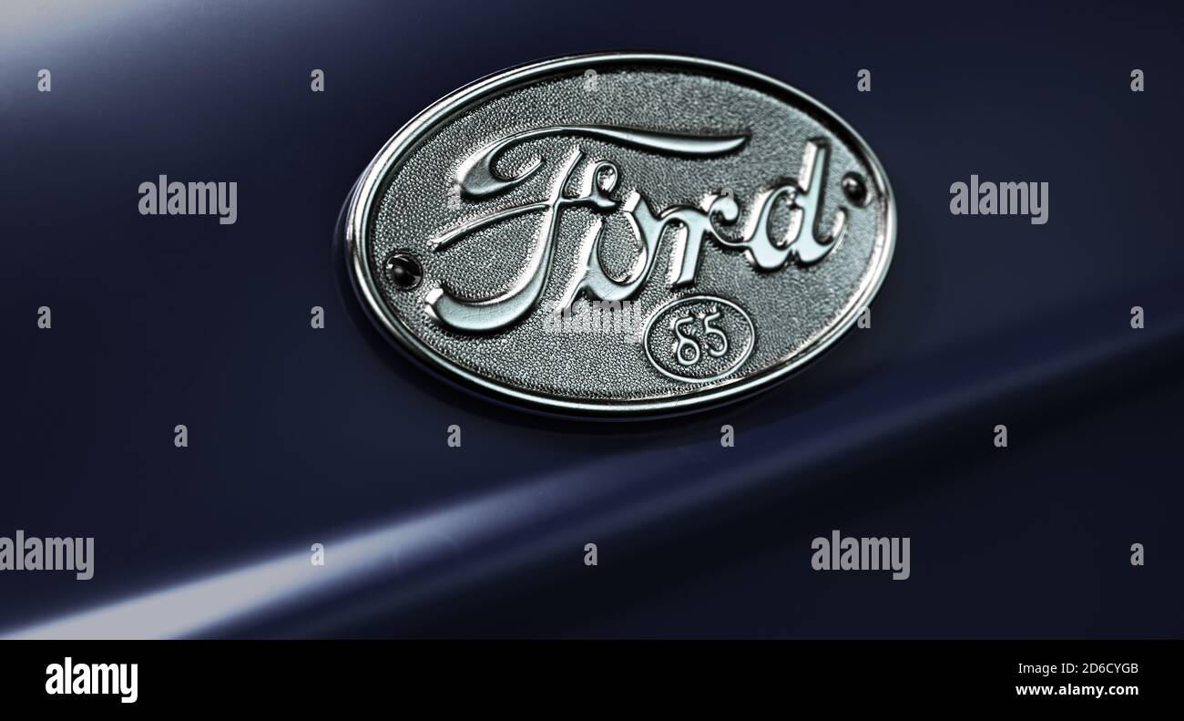 A closeup of a classic vintage chrome ford decal emblem on a car with a classic navy blue paint job, 29 June 2020 in Bristol, United Kingdom Stock Photo