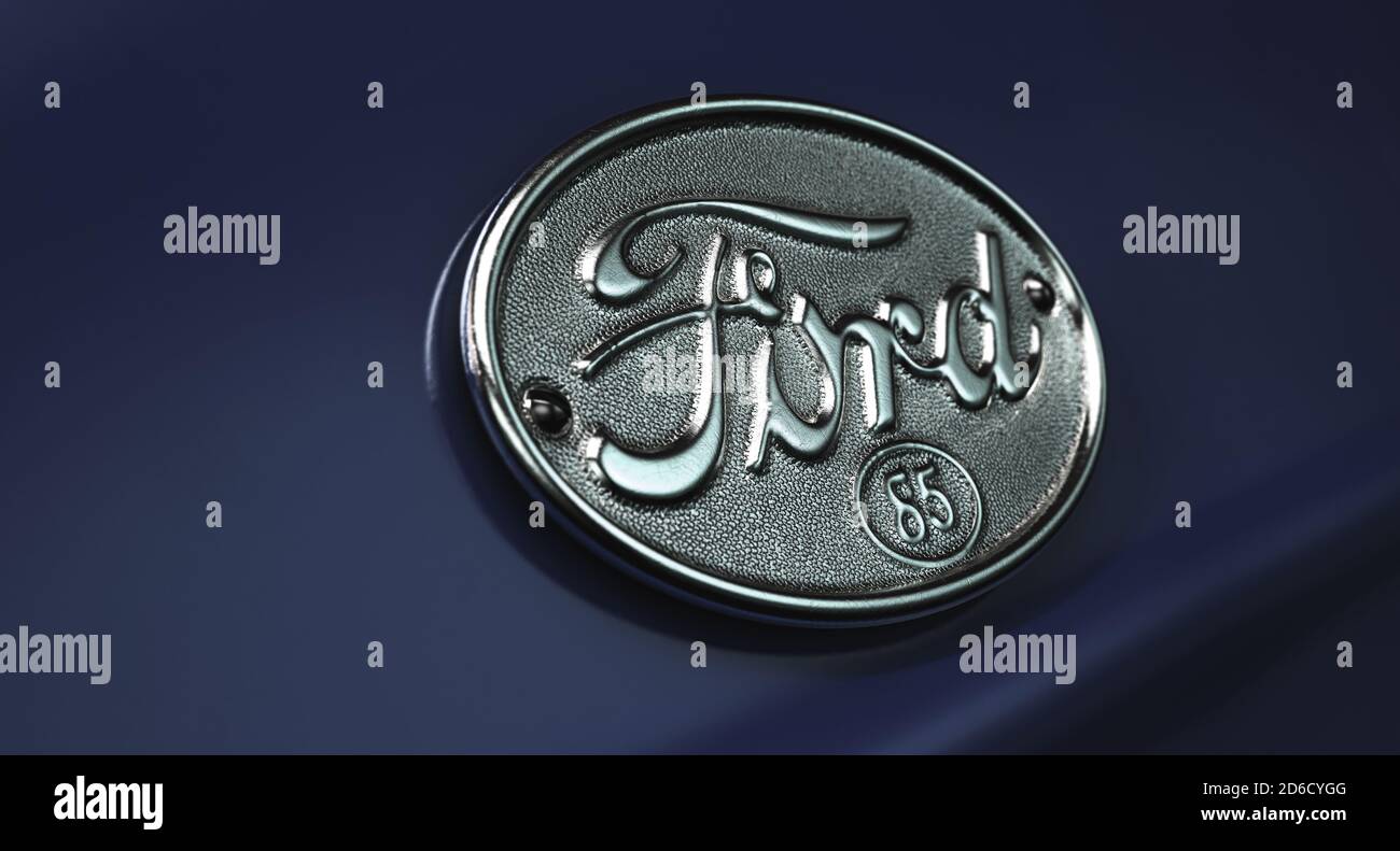 A closeup of a classic vintage chrome ford decal emblem on a car with a classic navy blue paint job, 29 June 2020 in Bristol, United Kingdom Stock Photo