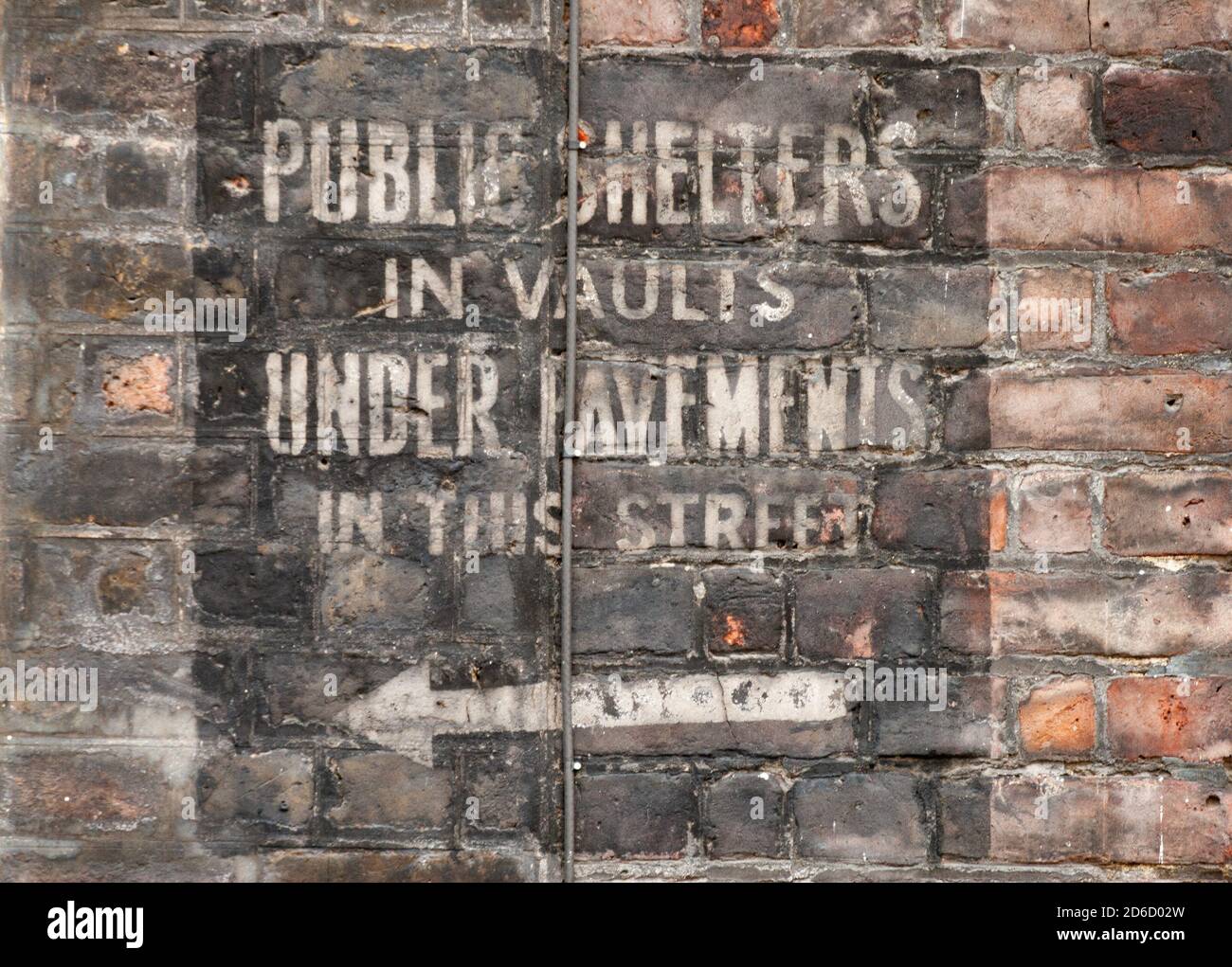 Faded painted sign on wall in Westminster dating from world war two saying public shelters in vaults under pavements in this street to show where air raid shelter is to get away from bombing during the blitz. 28 April 2009. Photo: Neil Turner Stock Photo