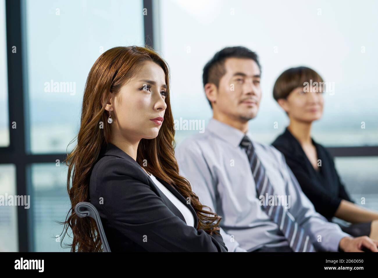 asian corporate executives listening attentively during presentation or training Stock Photo