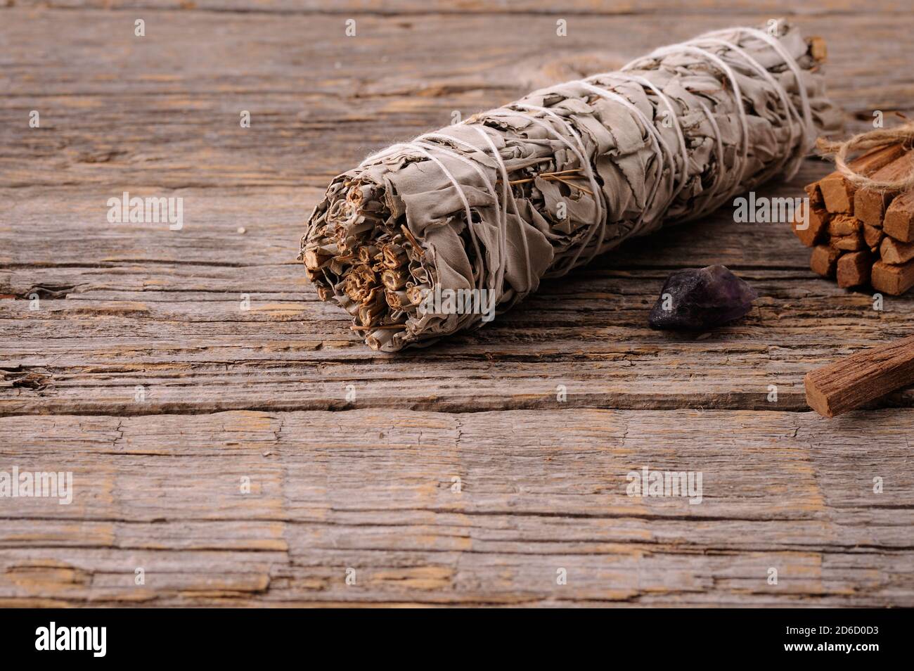 White sage smudge sticks  with palo santo sticks for ritual practice.  Healing the soul. Close up with space for text. Selective focus. Stock Photo