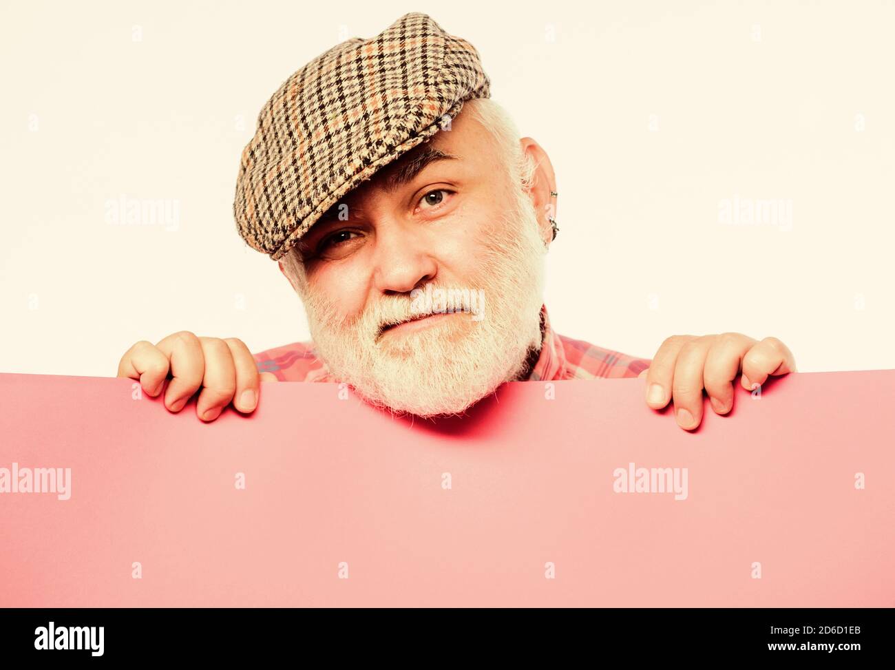 Weekend entertainment. Senior bearded man peeking out of banner place information. Public information. Advertisement elderly people. Announcement concept. Pensioner hold poster information copy space. Stock Photo
