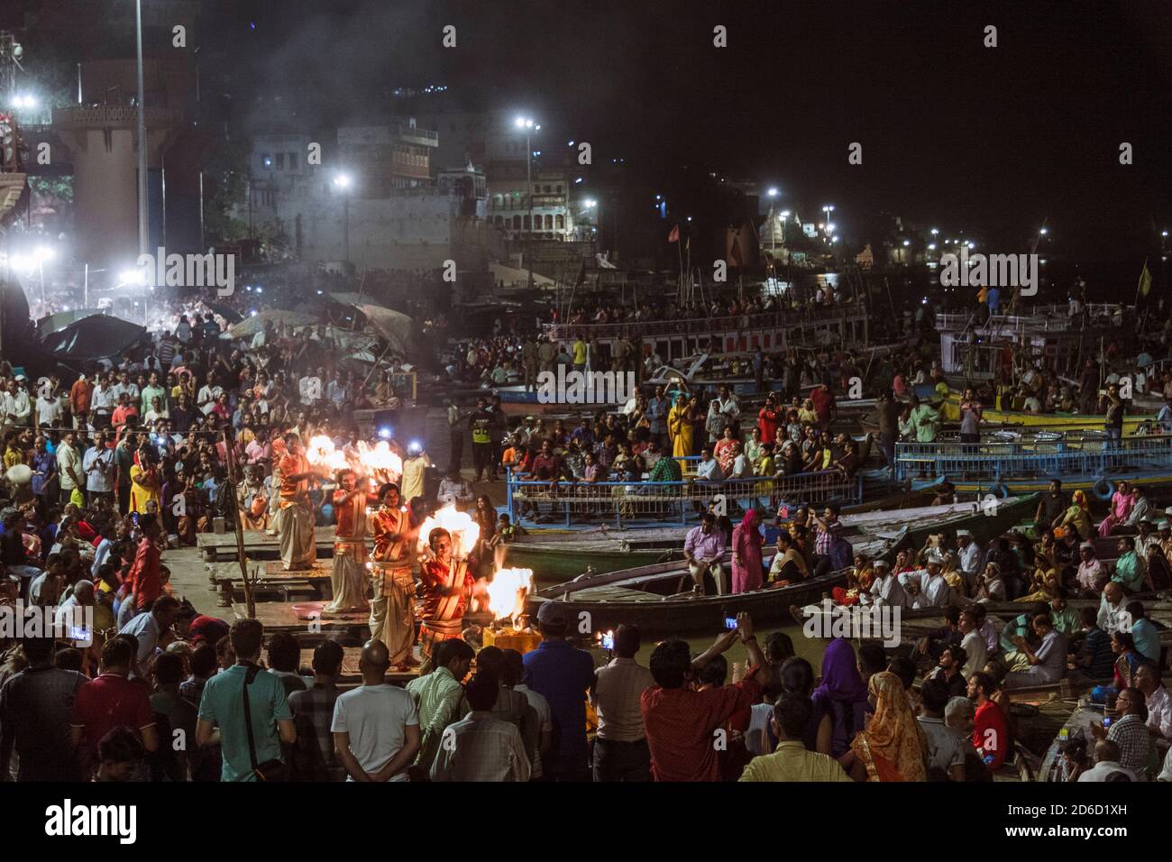 Varanasi, Uttar Pradesh, India : Hindu priests celebrate the Ganga Aarti ceremony at Dashashwamedh Ghat as a large group of spectators surrounds them. Stock Photo