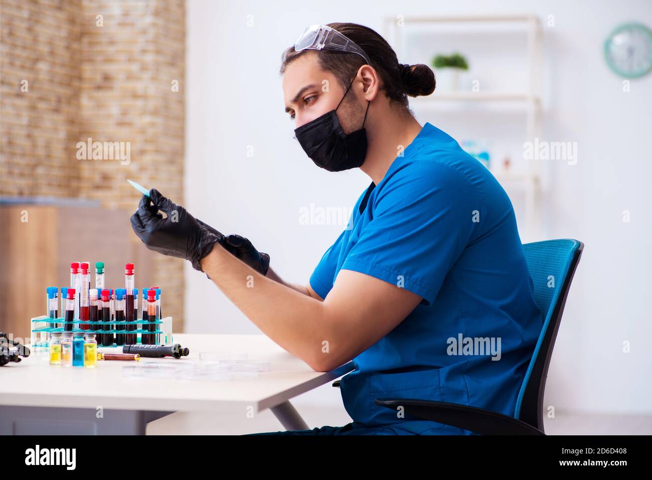 Male biochemist testing blood samples in pandemic concept Stock Photo ...