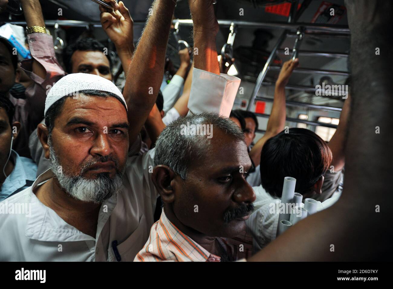 08.12.2011, Mumbai, Maharashtra, India - Commuters during rush hour in a completely overcrowded local train, which connects the center of the Indian m Stock Photo