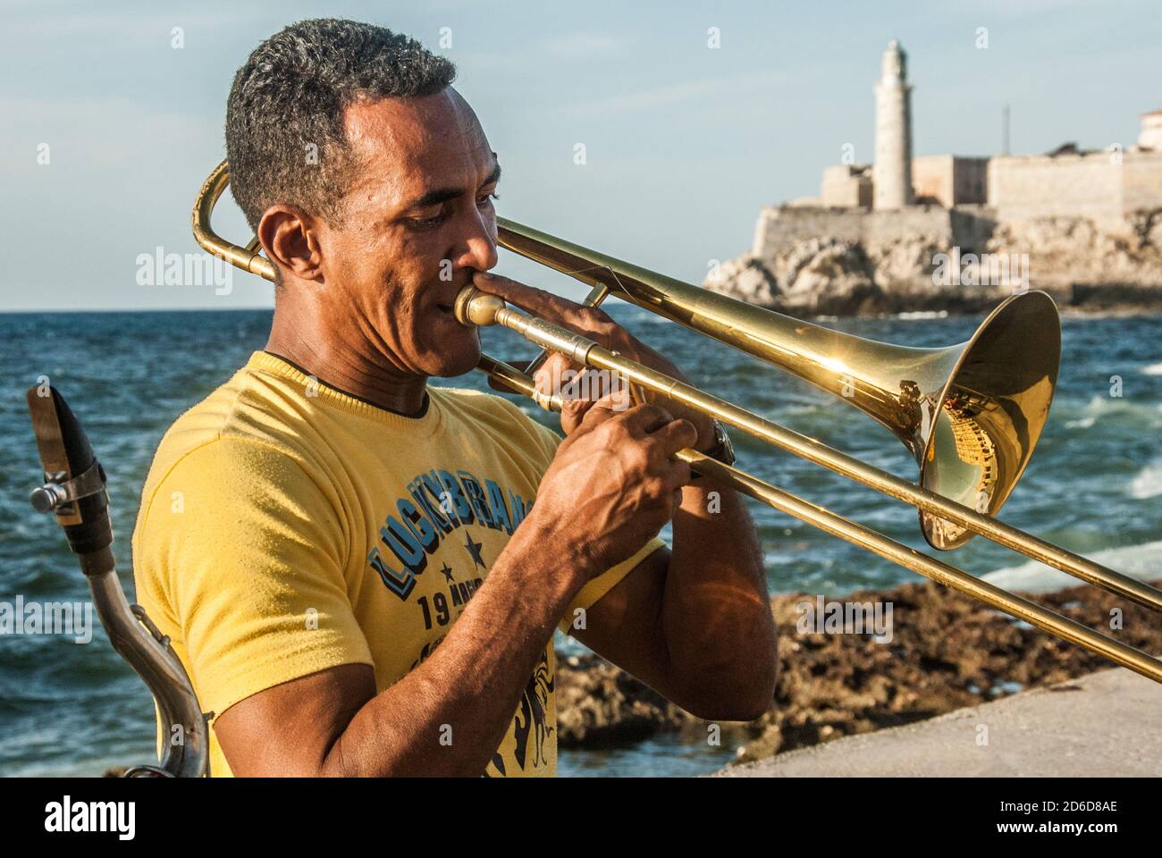 Trombone player, part of a group of musicians playing on the malecon