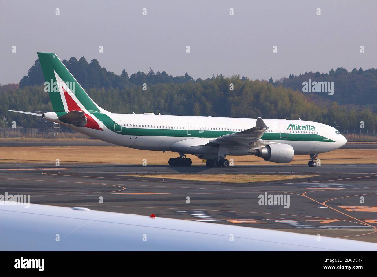 TOKYO, JAPAN - DECEMBER 5, 2016: Alitalia airline Airbus A330 taxiing at Narita Airport of Tokyo. The airport is the 2nd busiest airport of Japan (aft Stock Photo