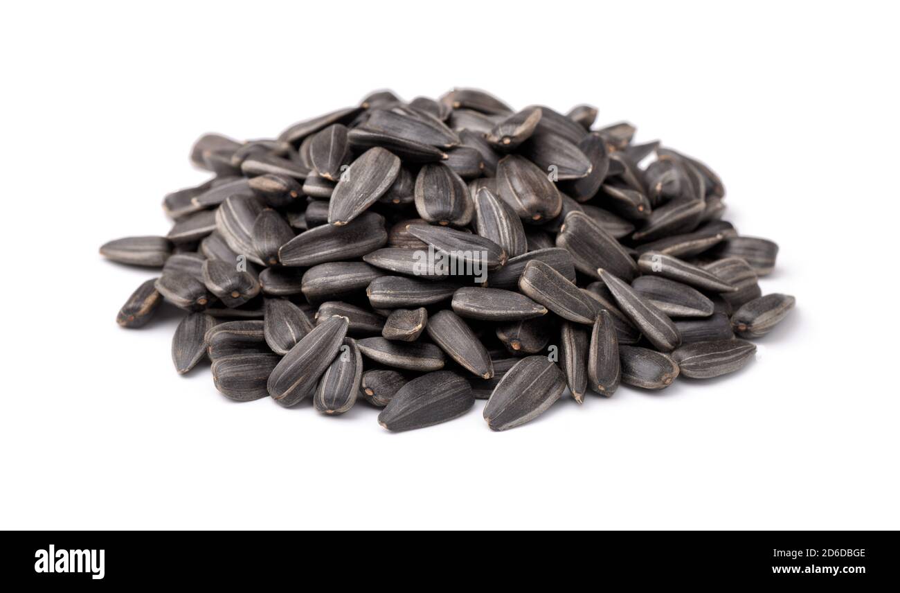 Pile of black sunflower seed isolated on white Stock Photo - Alamy